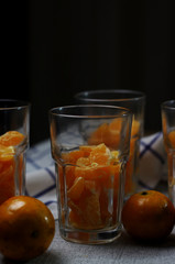 Preparing the tangerine in drinking glass to make a orange smoothy
