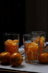 Preparing the tangerine in drinking glass to make a orange smoothy
