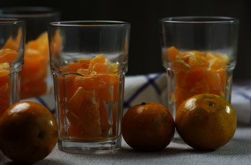 Preparing the tangerine in drinking glass to make a orange smoothy