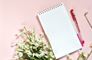 spring mockup notepad on a  background and snowdrops. delicate fletley background copy space place for text.