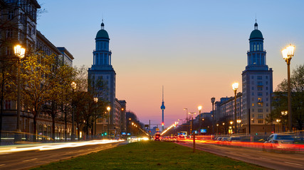 Fototapeta na wymiar The Frankfurt Gate, inner-city Friedrichshain district of Berlin, with view of the tv tower, blue hour, dusk