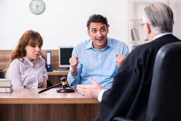 Young couple in the courthouse in divorce concept