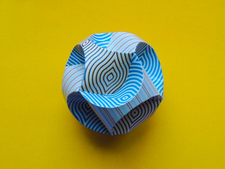Cardboard ball with a pattern on a colored background. Macro. Brightly. Colorfully.