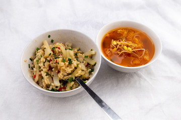 Cooked radish with rice that is called Mubap and kimchi bean sprout soup that is called kimchi kongnamul kuk