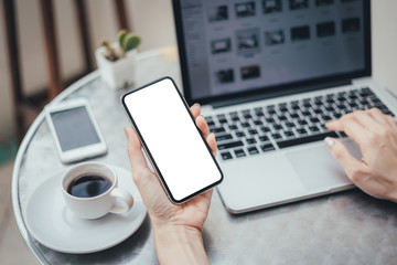 Mockup image blank white screen cell phone.man hand holding texting using mobile on desk at office.background empty space for advertise text.people contact marketing business,technology 