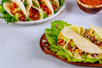 Mexican food flour tortilla stuffed with lettuce, meat and cheese.