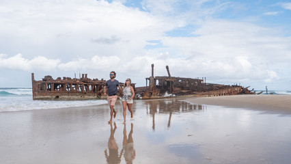 Couple walking on the Beach at SS Maheno Wreck on Fraser Island