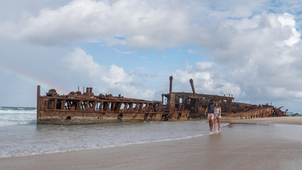 Couple walking on the Beach at SS Maheno Wreck on Fraser Island