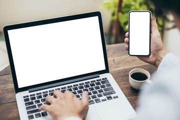 mockup image blank screen computer,cell phone with white background for advertising text,hand man using laptop texting mobile contact business search information on desk in cafe.marketing,design