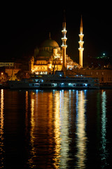 Fototapeta premium The New Mosque in early morning before sunrise with lights reflected in the Golden Horn Istanbul