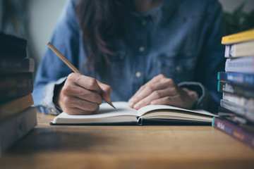 high school,university student study.hands holding pencil writing paper answer sheet.sitting lecture chair taking final exam attending in examination classroom.concept scholarship for education abroad