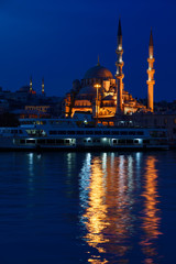 Fototapeta na wymiar The New Mosque with Nuruosmaniye at twilight early morning with lights reflected in the Golden Horn Istanbul