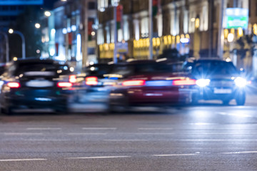 Fototapeta na wymiar car traffic with colorful lights illuminating dark road. blurred view