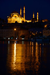Fototapeta na wymiar Lights of Suleymaniye Mosque largest in Istanbul reflected before dawn in waters of the Golden Horn
