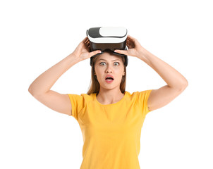 Shocked woman with virtual reality glasses on white background