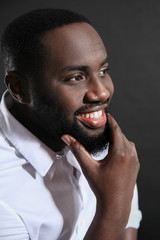 Stylish African-American man on dark background