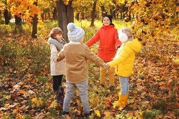 Cute little children playing in autumn park