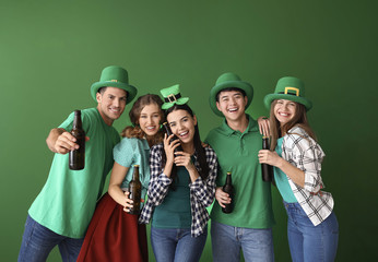 Friends with beer on color background. St. Patrick's Day celebration