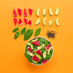 Bowl with tasty salad and ingredients on color background