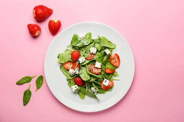 Plate with tasty salad on color background