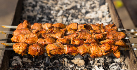 Meat slices prepare on fire. Baked meat on skewers.