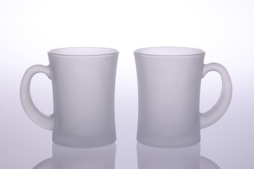 Two mug doff glass with holder for mock up or graphic resources isolated on white with reflection
