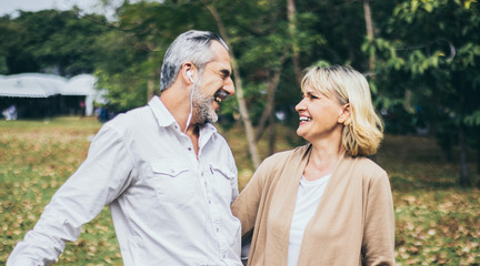 Fototapeta premium Lovely senior elderly happy couple man and woman with big laughing in romantic moment. Warm heart marriage and lover bonding and relationship. Husband and wife in love. Retired people photo concept...