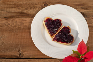 Heart shaped cookies with jam, top view on rustic wood. Valentines Day