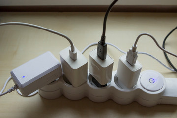 Many devices on charge. Power strip with 4 outputs for plugs and schuko. European Power Strip 4 Outlets.