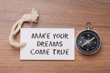 make your dream come true -  inspirational advice handwriting on label with compass