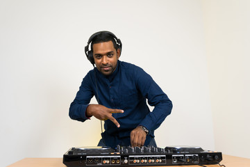 Male DJ playing music on white background