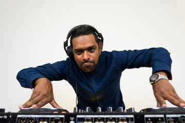 Male DJ playing music on white background