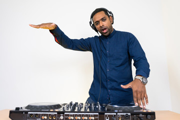 Male DJ playing music on white background