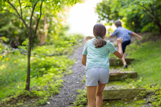 Portrait of happy siblings laughing and playing outside