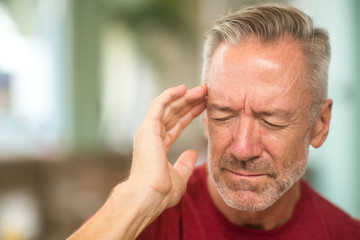 Fototapeta premium Mature man having a headache stock photo