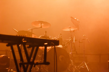 Musical instruments on the stage filled with orange light