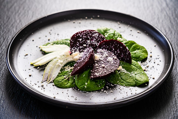 Beetroot with cottage cheese on stone plate