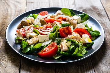 Tasty salad - vegetables , feta cheese and barbecue chicken fillet