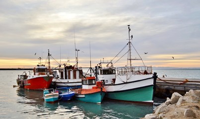 Seascape with fishing boats in a small harbor