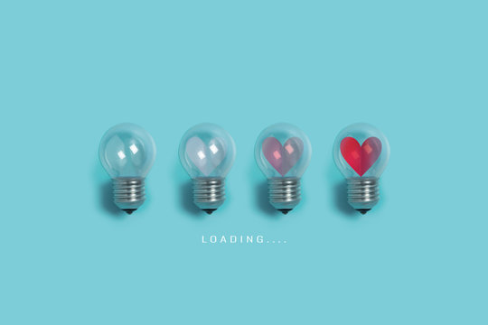 Red hearts in light bulbs. Loading progress bar on blue background. Valentine's day, Creative idea, Love, Inspiration Concepts.
