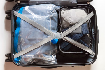 Crossed belts on vacuum compress bag for clothes and expanded your space suitcase. 