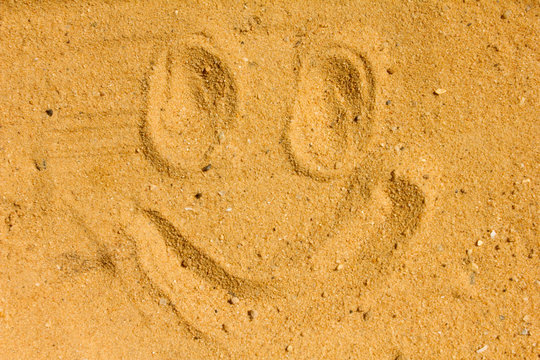 Smiley face images emotion Draw on the sand and nature