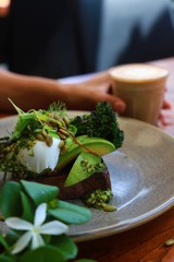 Organic Green Vegetables and Herbs served on Rye Toasted Sourdough with Poached Eggs, Pesto and Roasted Pumpkin Seeds