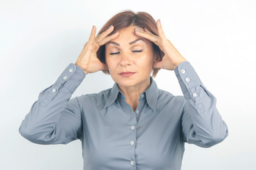 Beautiful young business girl with closed eyes thinks over her project on a white background. thoughts and stress. relaxation and emotions