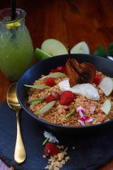 Crunchy Granola with dehydrated organic pear, sliced green apple, strawberries and vanilla bean yoghurt