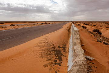 Marsa Matrouh, Egypt A highway through the Sahara desert and sand drifts.