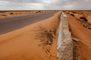Marsa Matrouh, Egypt A highway through the Sahara desert and sand drifts.