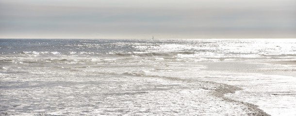 Seascape with late afternoon light on the beach