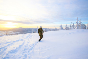 Pilot astronaut is on a snow-capped top. Astronaut in a protective suit and helmet.