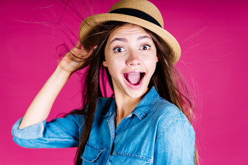 The gorgeous emotion of surprise on the face of the girl in the hat, her eyes are wide, her mouth...